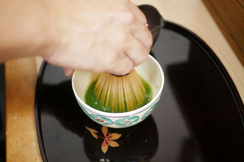茶筅を親指、人差し指、中指で持ち、手首のスナップで茶筅を前後に素早く動かす